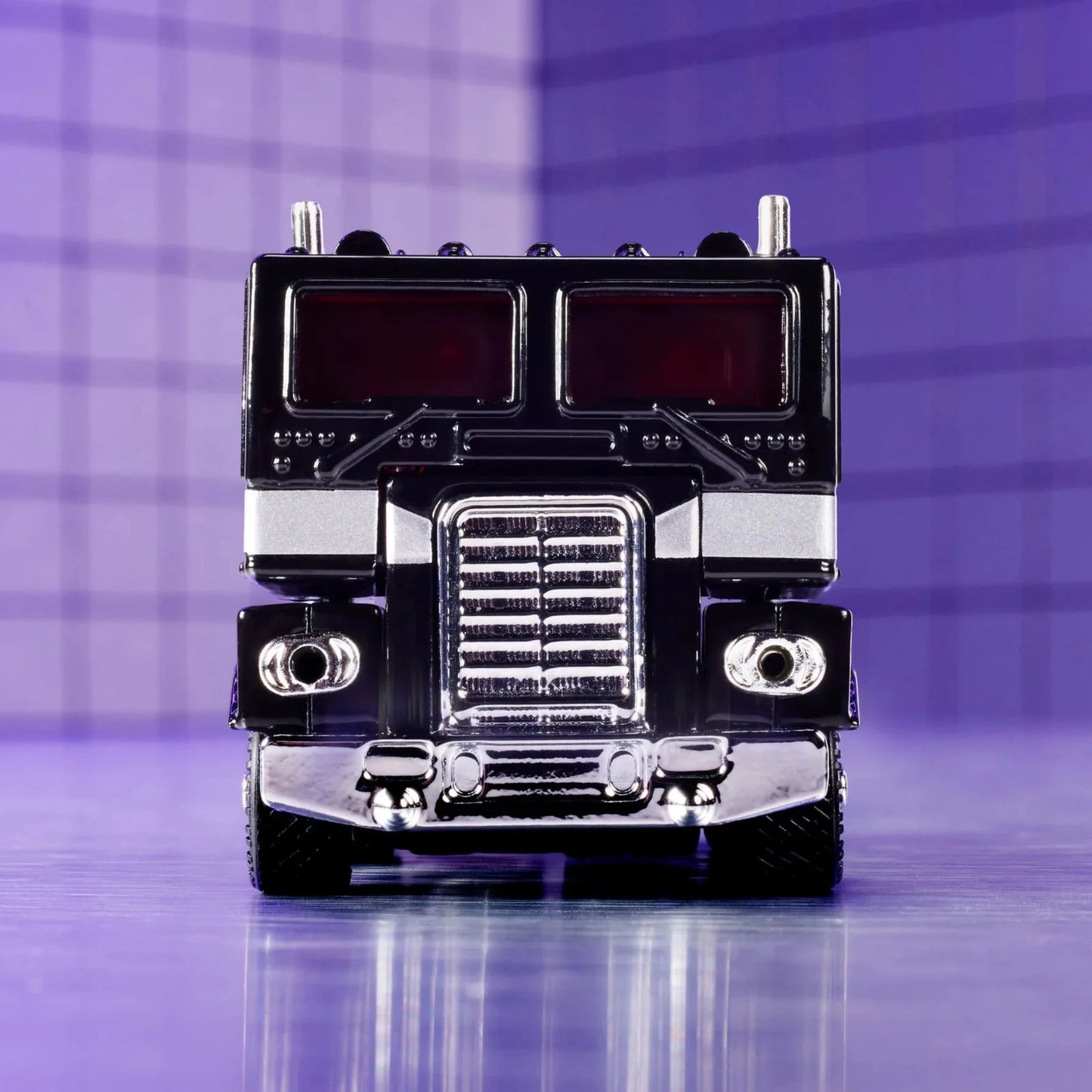 Hot Wheels Collectors Edition Nemesis Prime Truck – hochwertiges Sammlermodell mit glänzender Chromoptik, roter Beleuchtung und detailreicher Frontansicht im Retro-Stil.
